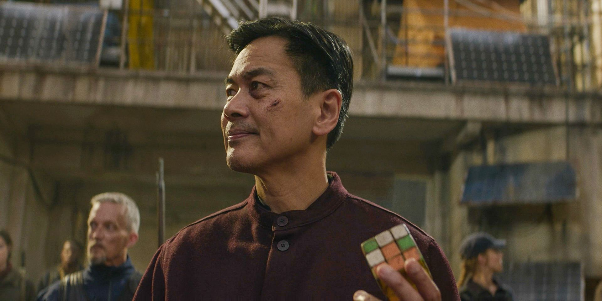 Losang (Joel de la Fuente) holding a Rubik's Cube in The Walking Dead: Daryl Dixon Season 2 Ep 5