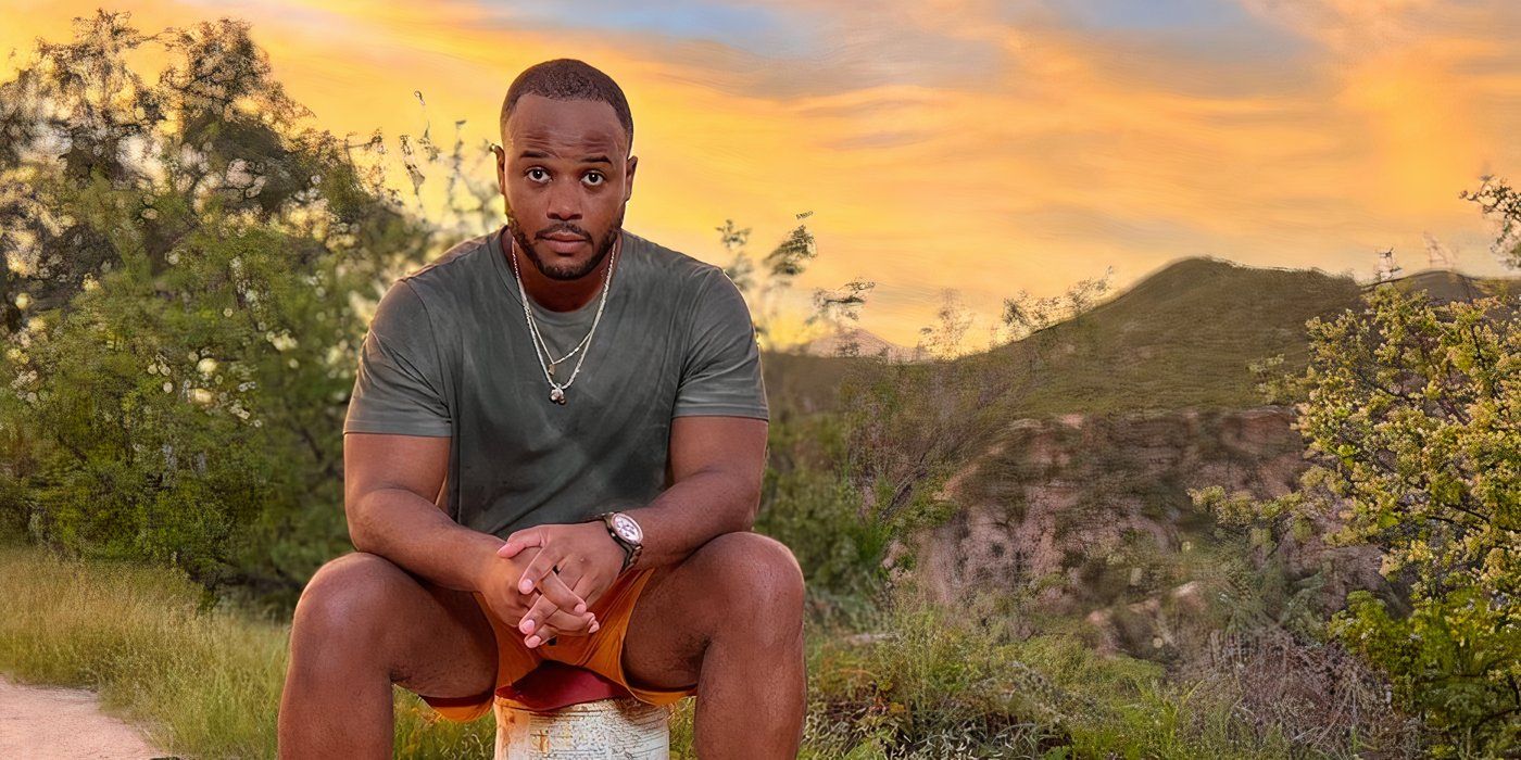 Love Is Blind season 7 Tim Godbee seated on a rock looking serious with sunset in the background.