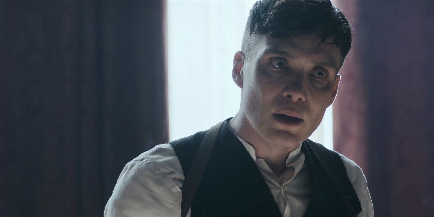 Tommy standing in front of a window in Peaky Blinders