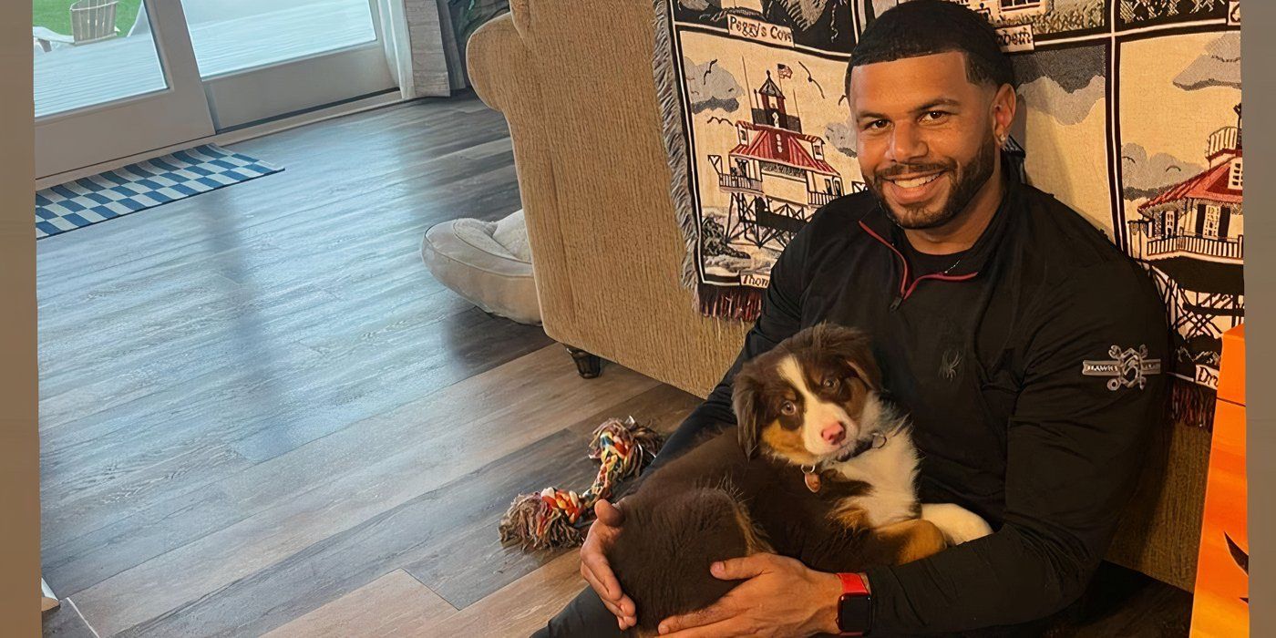 Love Is Blind Tyler Francis seated on the floor holding his dog