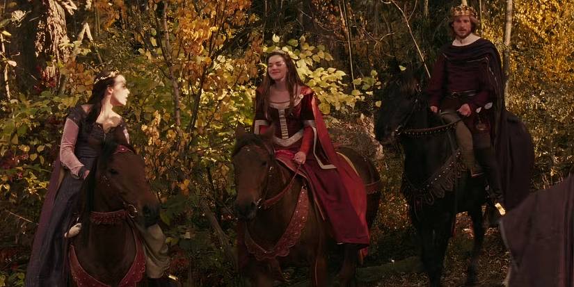 Adult Lucy, Susan, and Peter riding horses through a forest in The Lion, the Witch and the Wardrobe.