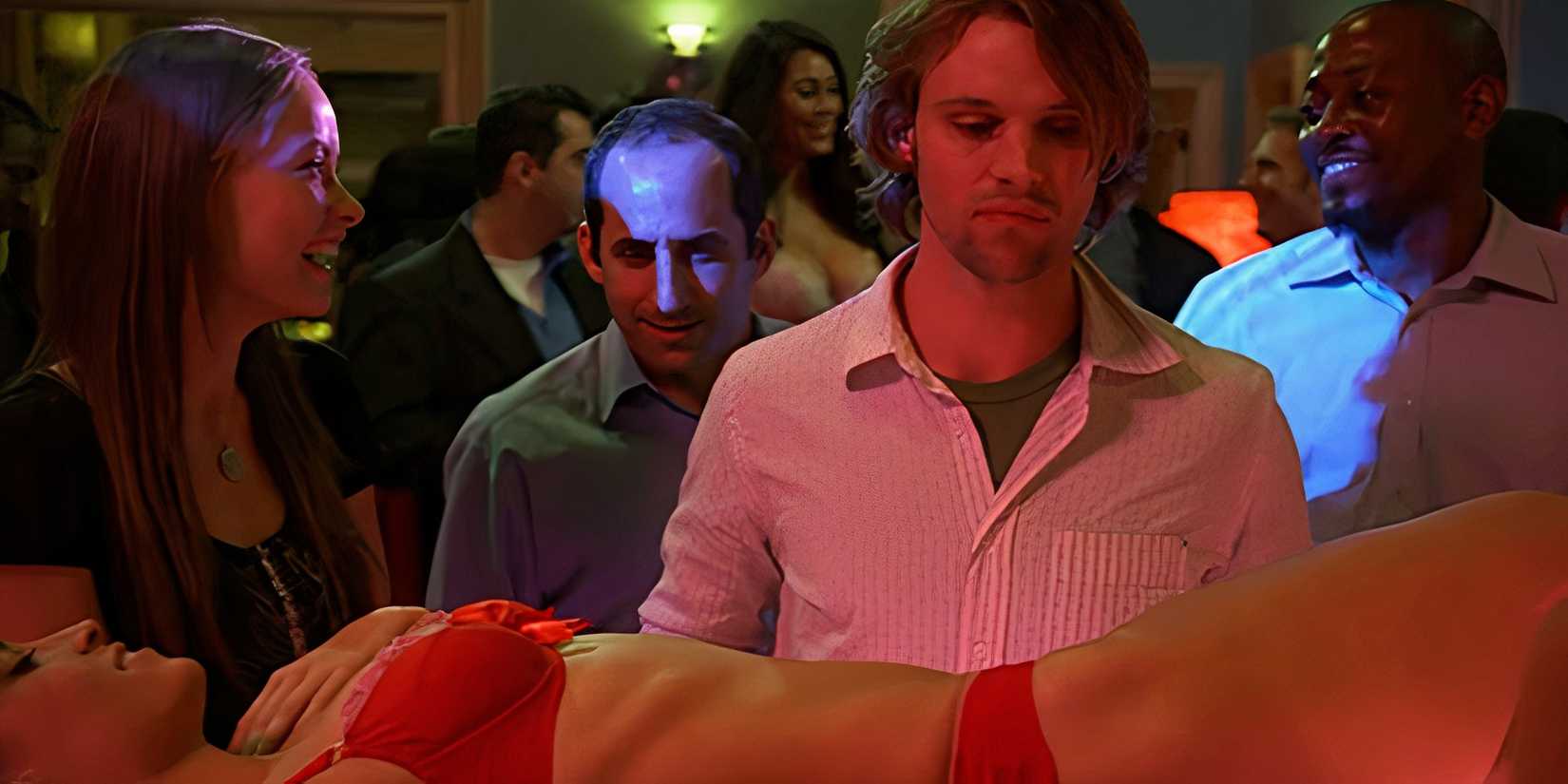 Taub and Foreman watching as Chase prepares to do a shot off of a stripper's body in the House episode House Divided.