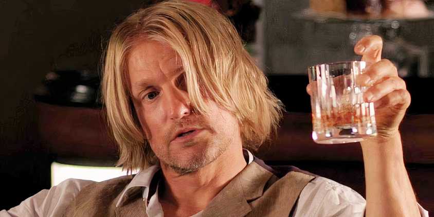Woody Harrelson as Haymitch with a drink in his hand in The Hunger Games