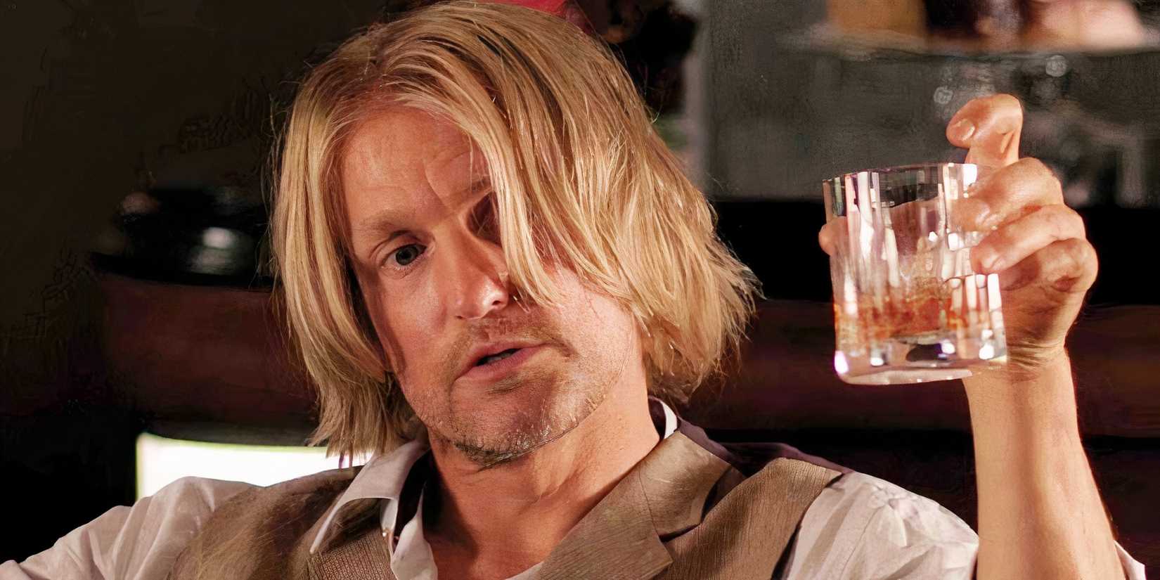 Woody Harrelson as Haymitch with a drink in his hand in The Hunger Games