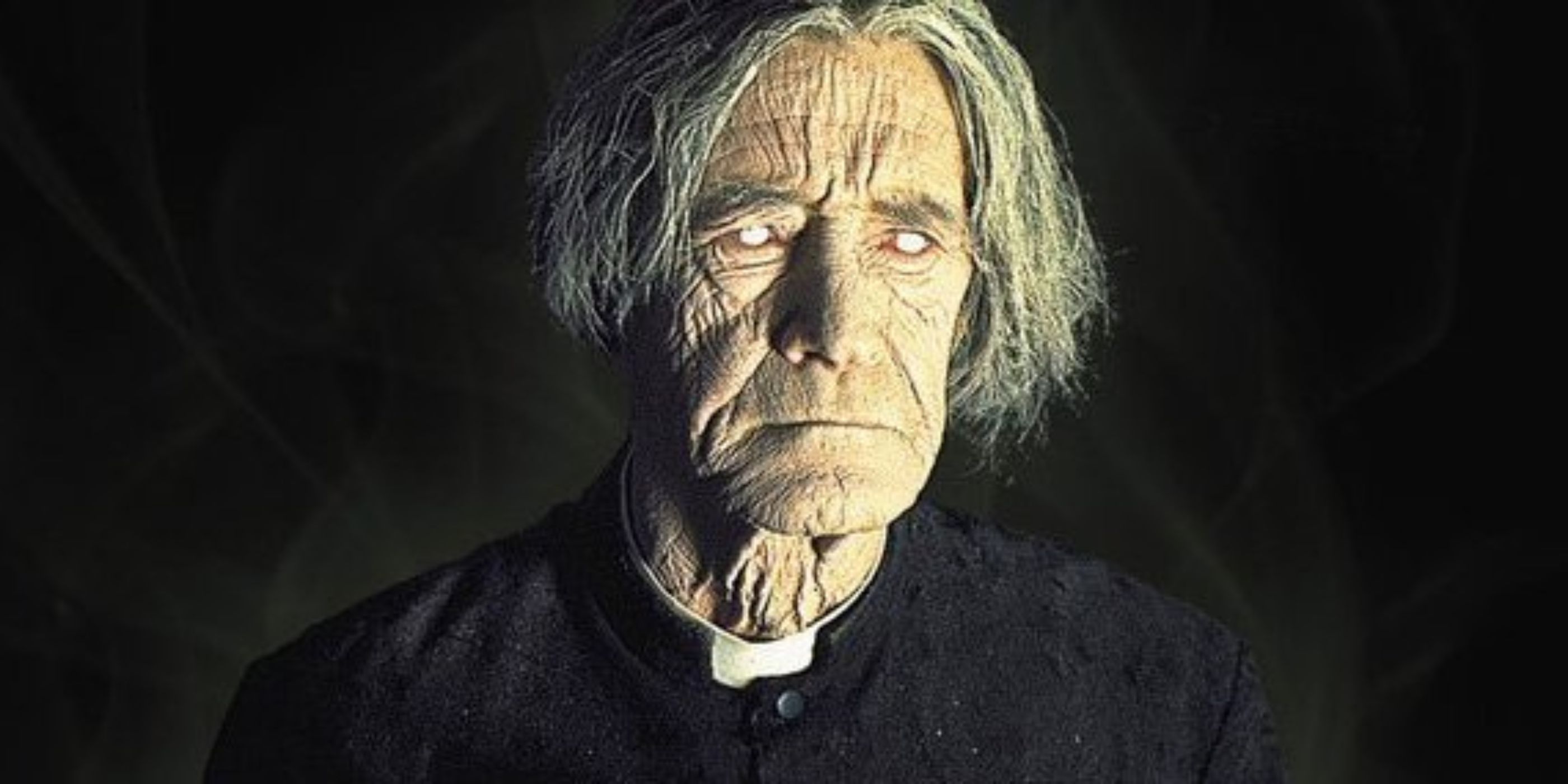 An undead priest with white eyes dressed in priest clothes stares ahead from the movie The Sentinel