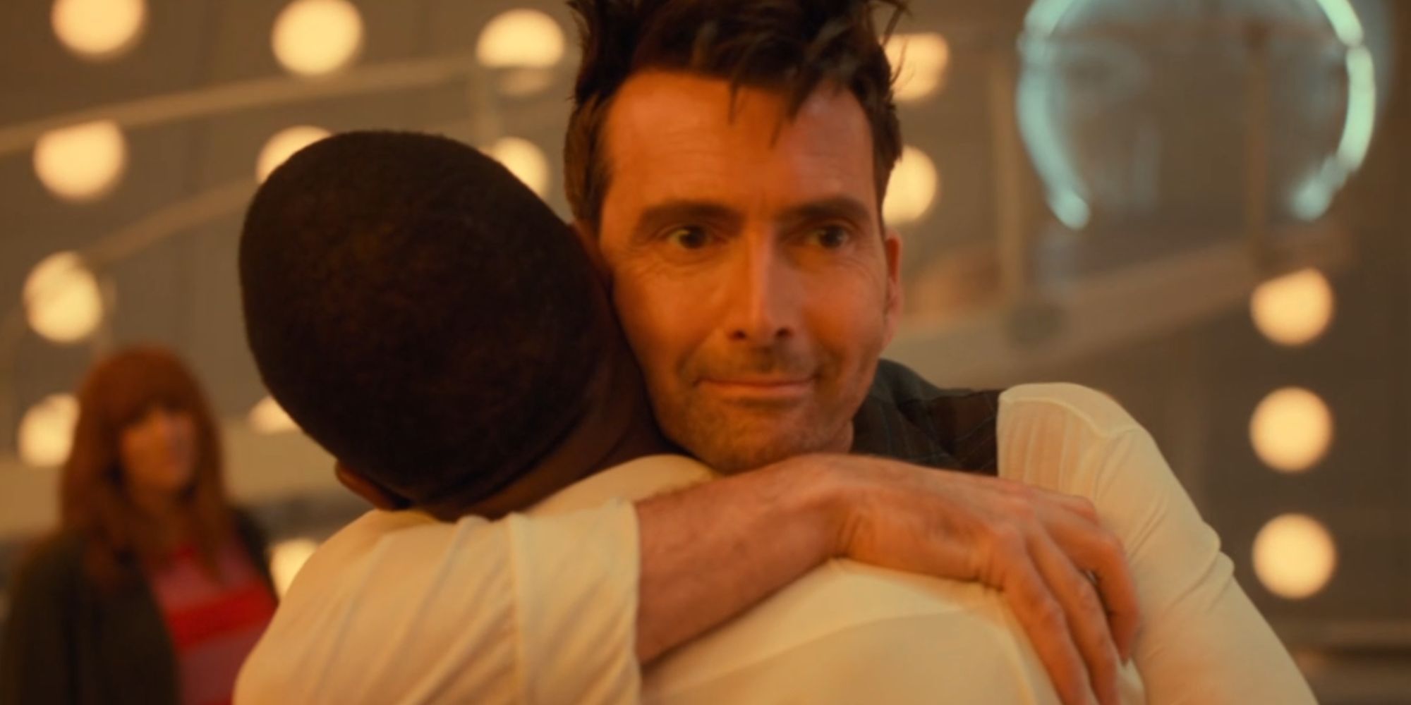 David Tennant's Fourteenth Doctor smiling in Doctor Who as he hugs Ncuti Gatwa's Fifteenth Doctor