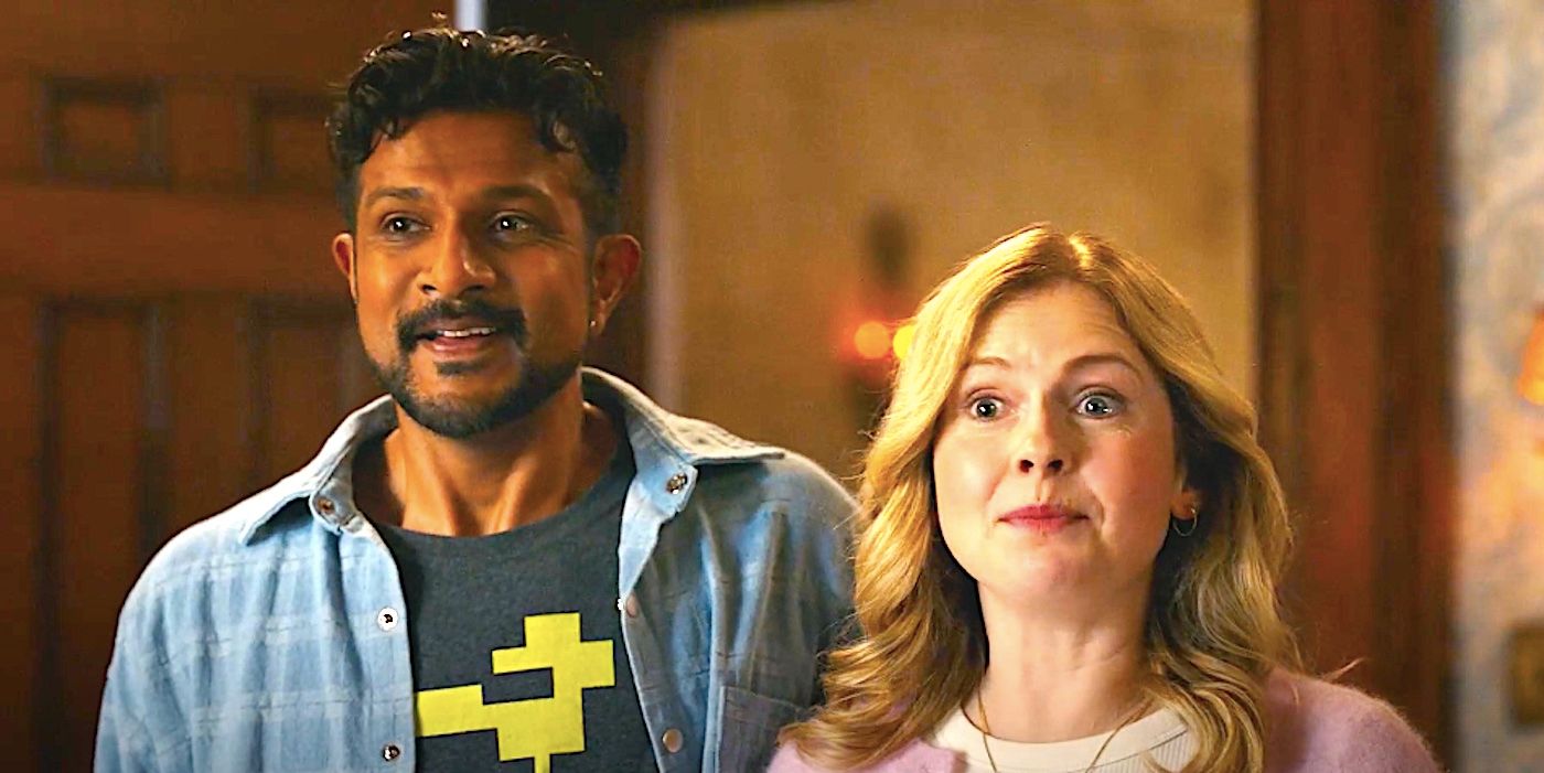 Utkarsh Ambudkar&rsquo;s Jay and Rose McIver&rsquo;s Sam stand smiling in a doorway in Ghosts season 4