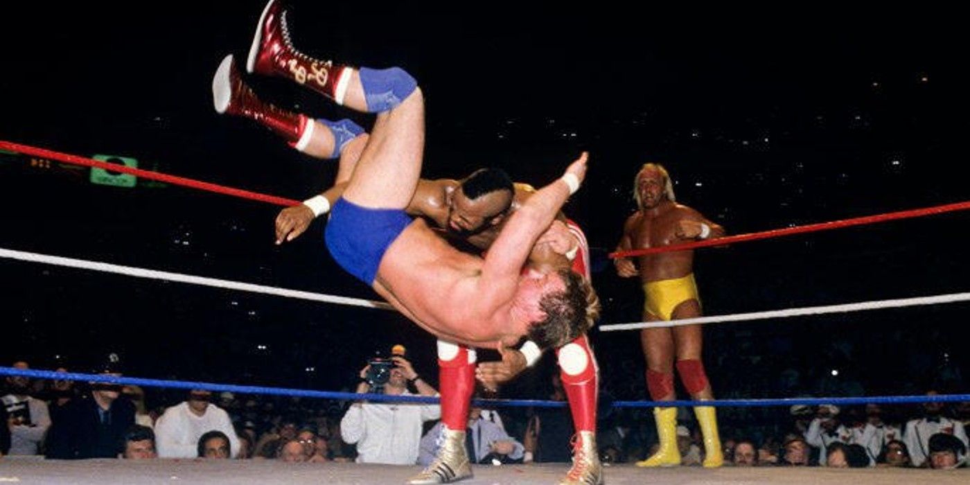 WWE Champion Hulk Hogan watches Mr. T scoop slam Rowdy Roddy Piper at WrestleMania 1