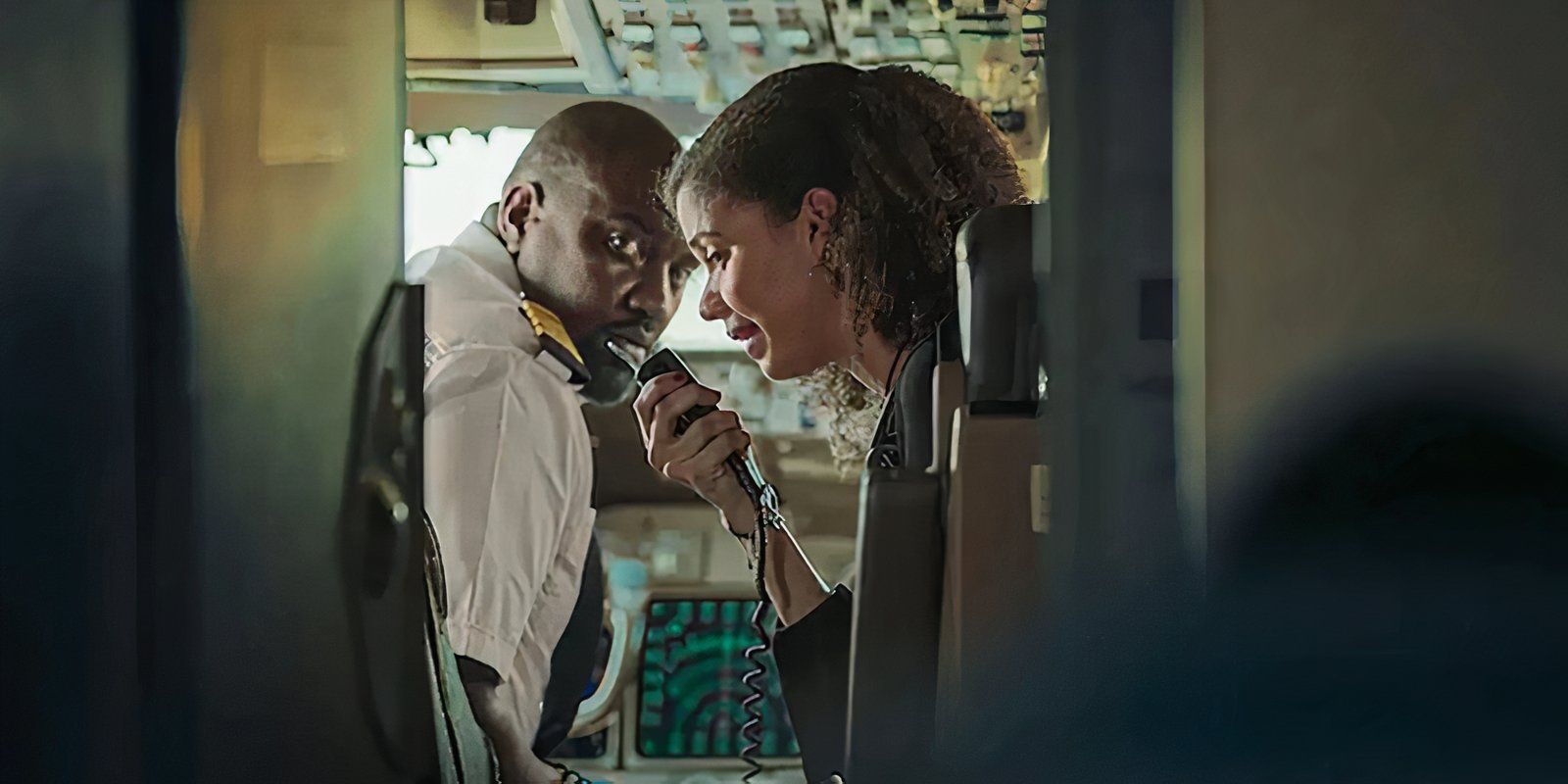 A crew member and pilot talk in the cockpit in Hijack '93