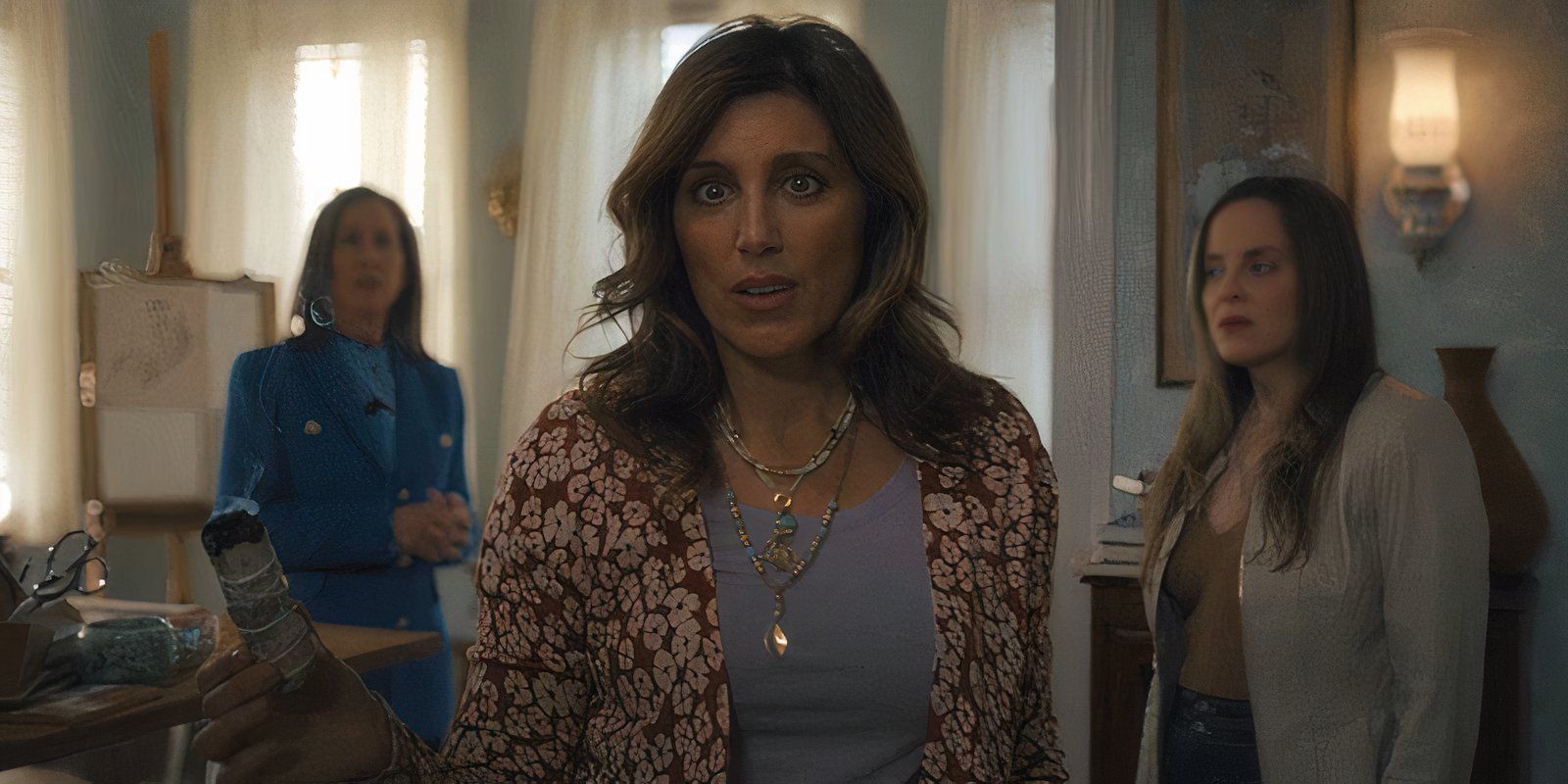 A psychic holds a bundle of burning sage in Apple TV+&rsquo;s Before
