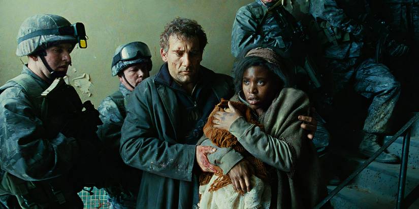 Theo (Clive Owen) hugging Kee (Clare-Hope Asнιтey) as they walk through a group of soldiers in Children of Men.