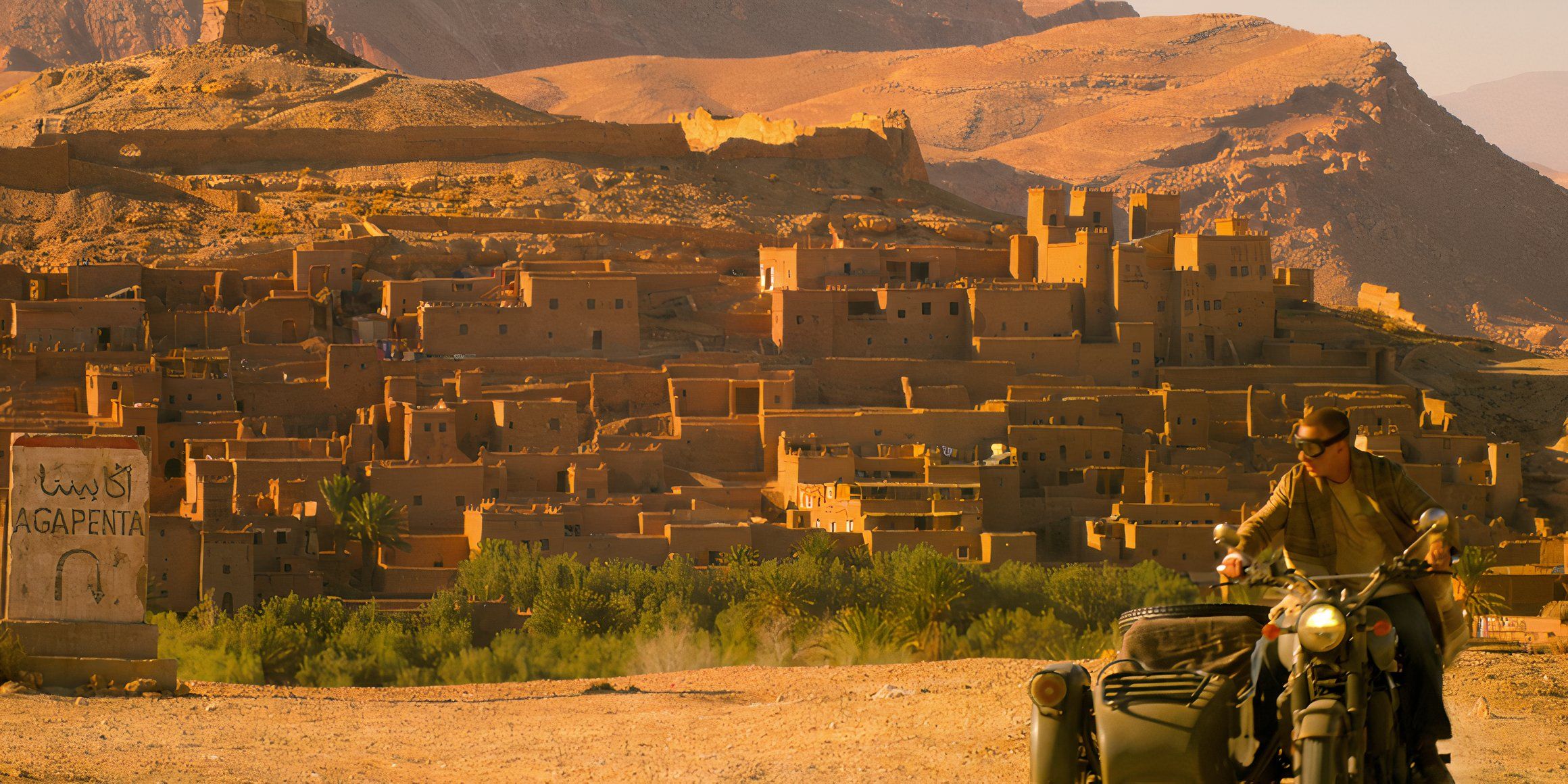 A sign for the city of Agapenta alongside a man on a motorbike with stone buildings in the background in Morocco in Outer Banks season 4