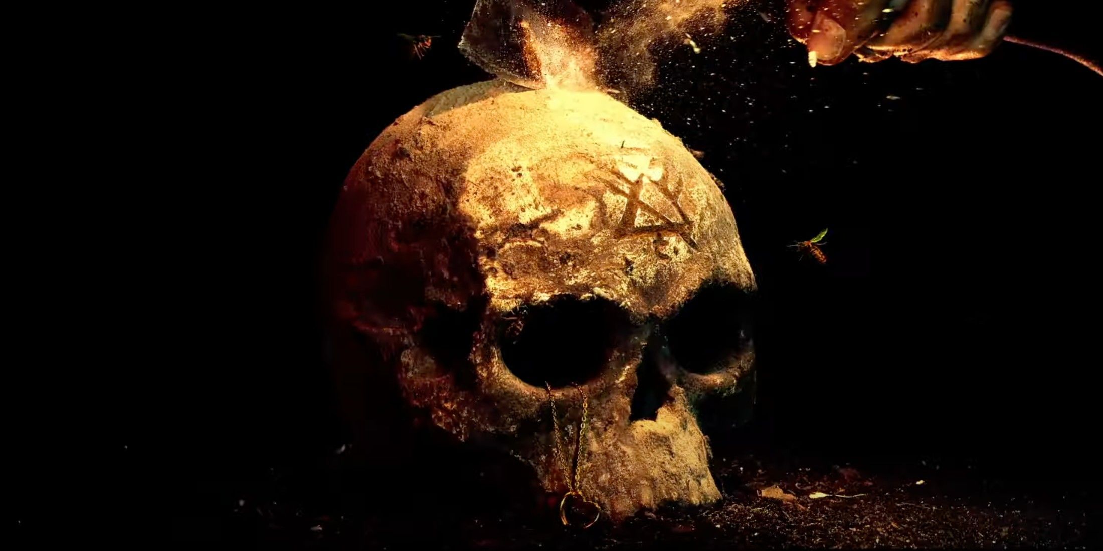 A skull with the symbol and Jackie's heart necklace being smashed in Yellowjackets season 3 trailer