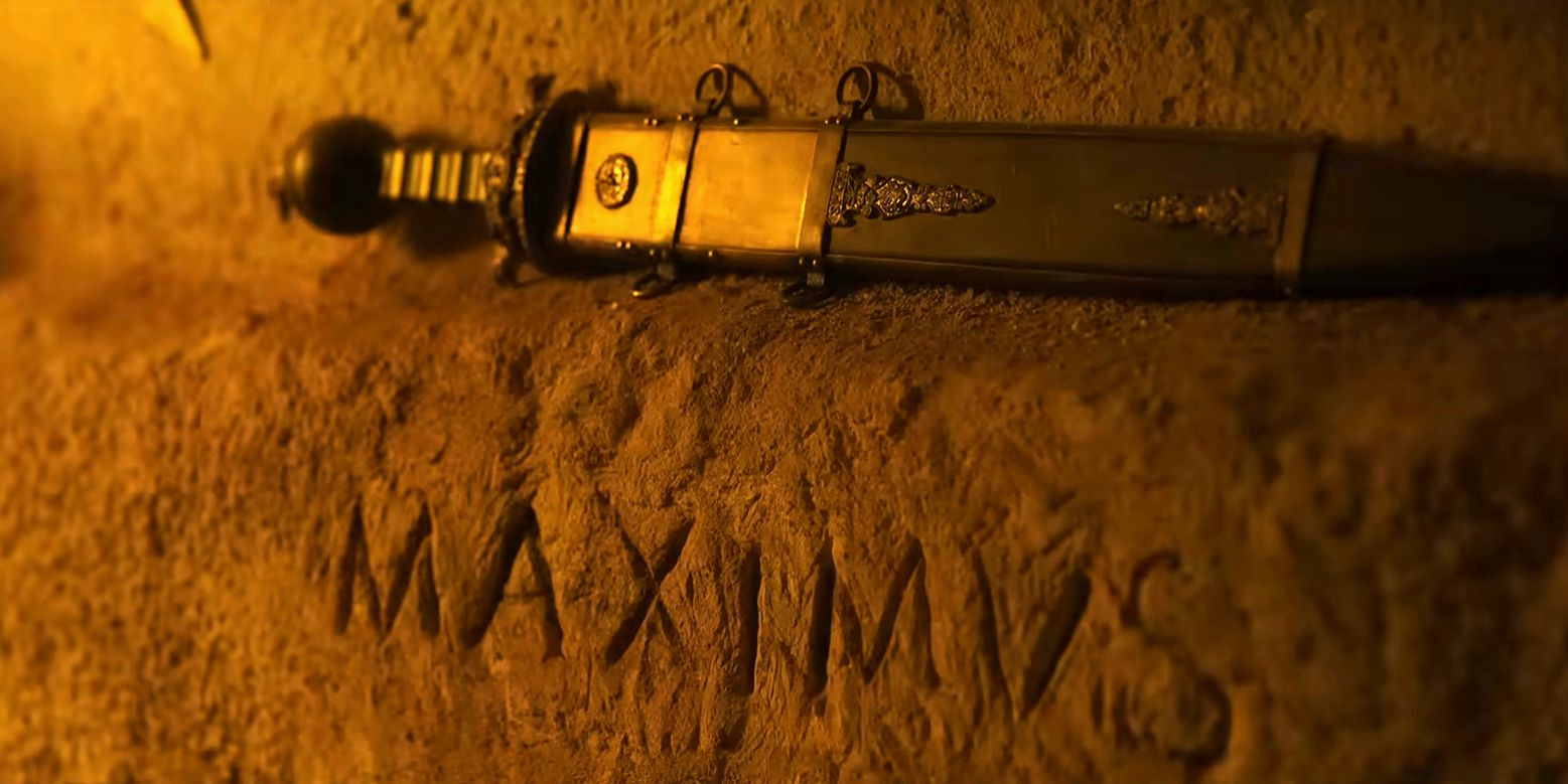 A sword on a shrine with Maximus carved into the wall in Gladiator 2