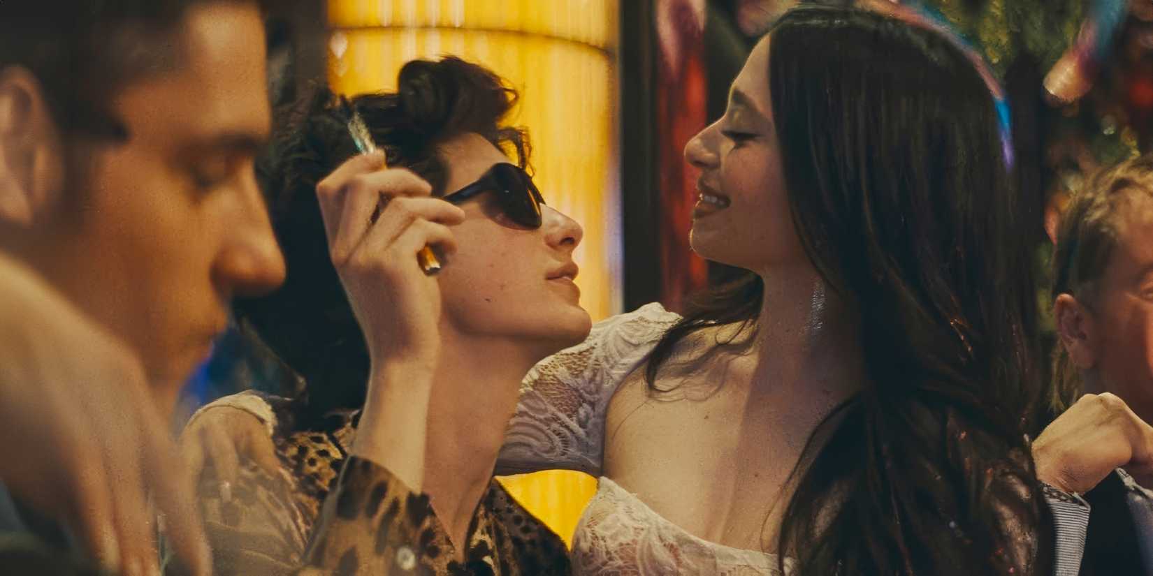 Ivan (Mark Eidelshtein) and Ani (Mikey Madison) looking at each other lovingly in ANORA
