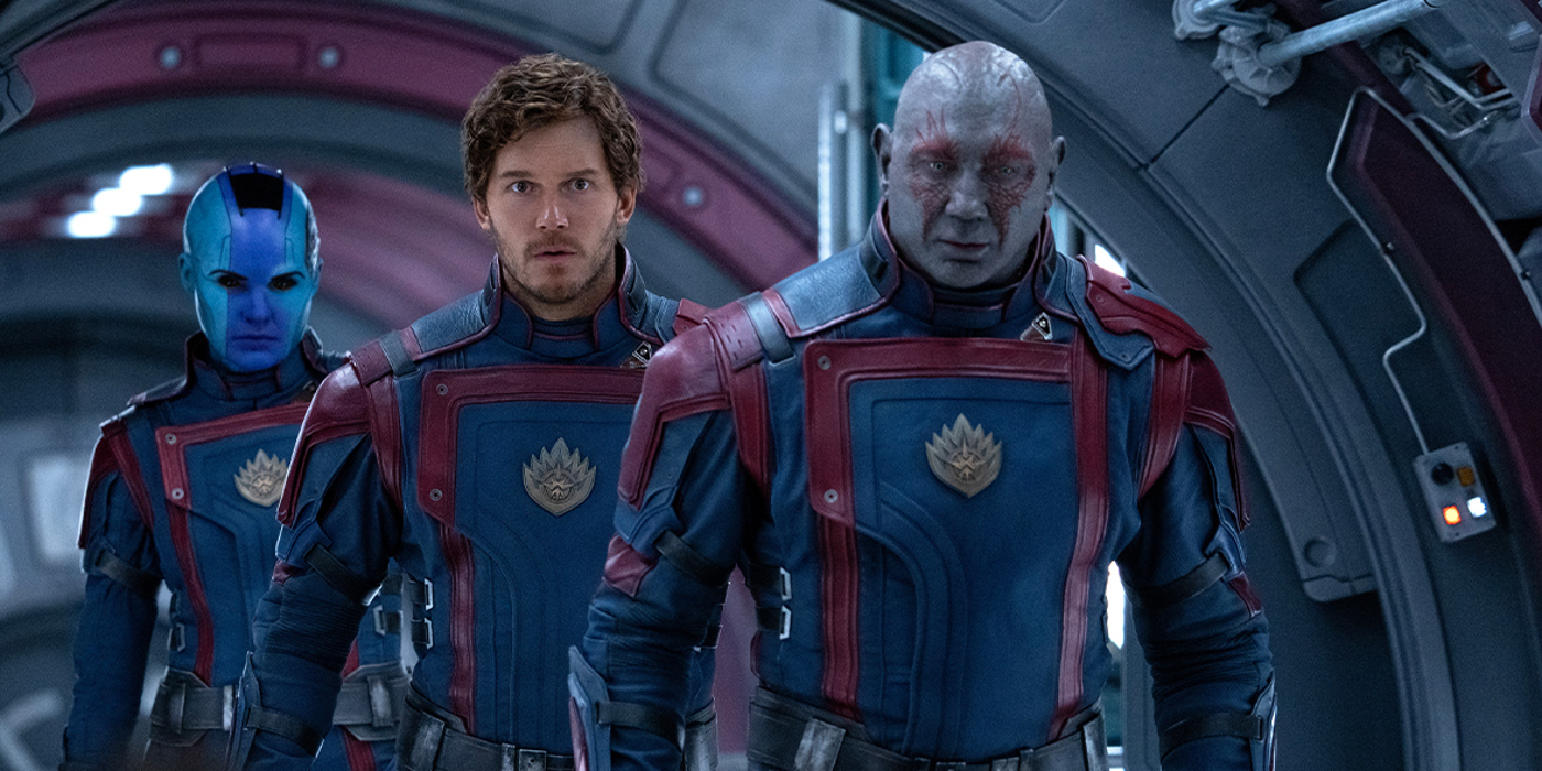 Dave Bautista as Drax standing in front of Chris Pratt as STar Lord standing in front of Karen Gillan as Nebula in Guardians of the Galaxy Vol. 3