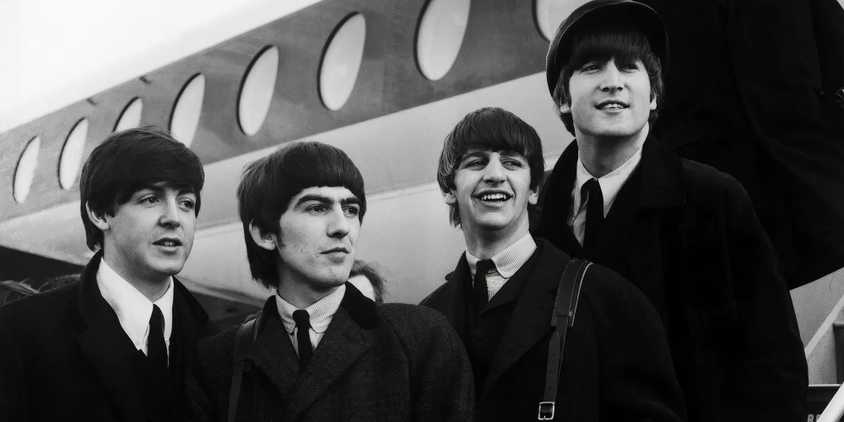 The Beatles outside of a plane in Beatles '64.