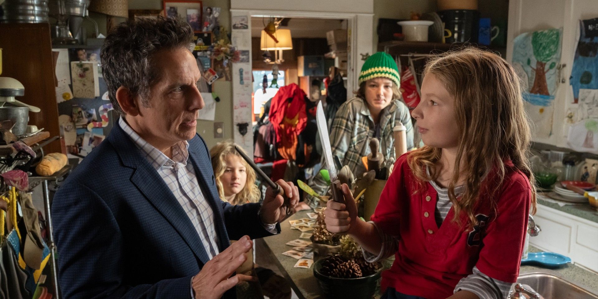 Ben Stiller facing Ulysses Janson, who holds a knife up, while two boys watch in the background in Nutcrackers