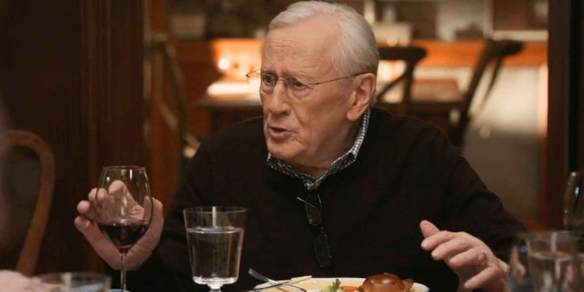 Blue Bloods Henry sitting at the family dinner table making a point