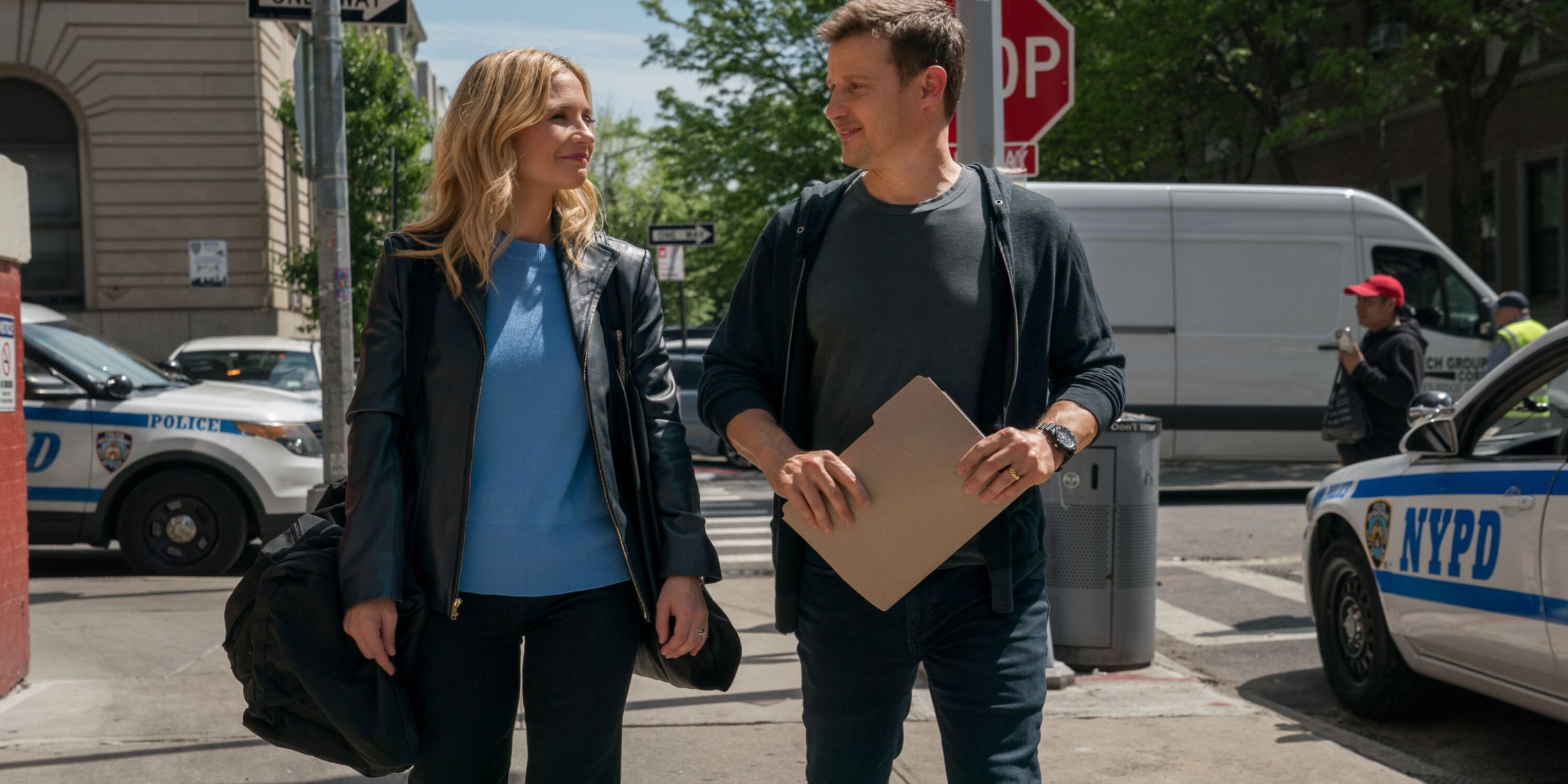 Blue Bloods Jamie and Eddie walking together down the street with a file in Jamie's hands