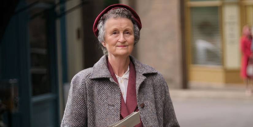 Miss Higgins (Georgie Glen) looks happy on the street in Call the Midwife