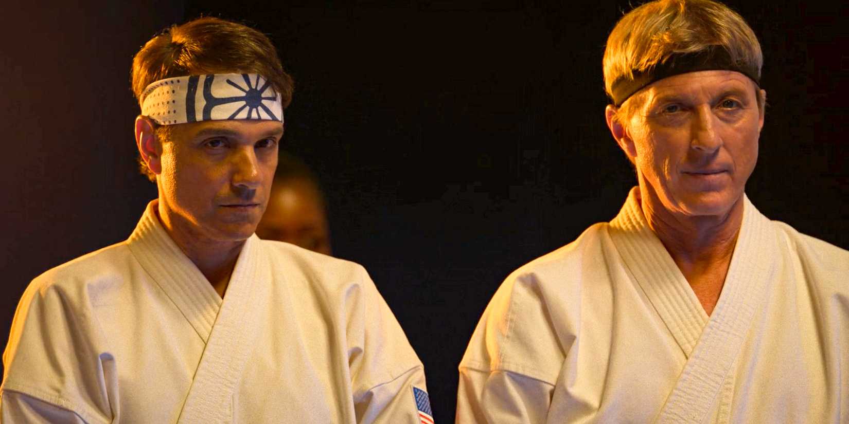 Daniel LaRusso (Ralph Macchio) and Johnny Lawrence (William Zabka) looking serious during the Seikai Taikai in Barcelona in Cobra Kai Season 6 Ep 6
