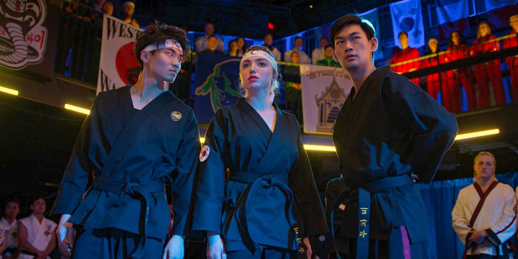 Tory Nichols (Peyton List) between two Cobra Kai teammates during the first round of the Sekai Taikai in Cobra Kai Season 6 Ep 6