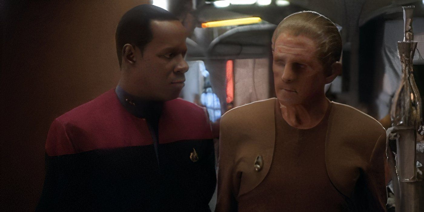 Commander Ben Sisko (Avery Brooks) talks to Constable Odo (Rene Auberjonois) on the promenade in DS9 The Alternate