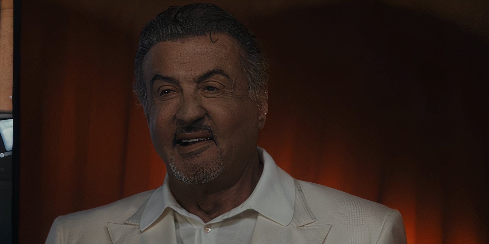 Dwight Manfredi (Sylvester Stallone) smiling and wearing a white suit in Tulsa King season 2, episode 10