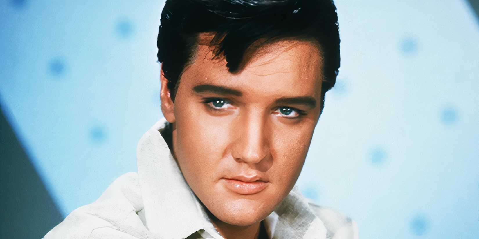 Elvis Presley in front of a blue background