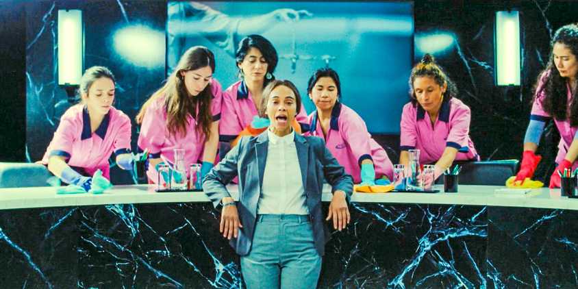 Rita Moro (Zoe Saldana) with a group of female janitors behind her in Emilia Pérez