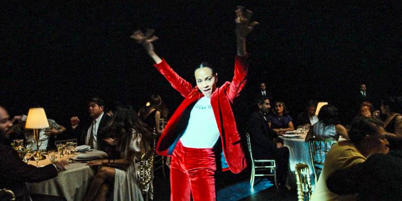 Rita Moro (Zoe Saldana) performing a dance during a fundraising event for the NGO, La Lucecita in Emilia Pérez