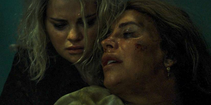 Emilia Pérez (Karla Sofía Gascón) confesses to Jessi (Selena Gomez) before dying that she is Manitas del Monte in Emilia Pérez