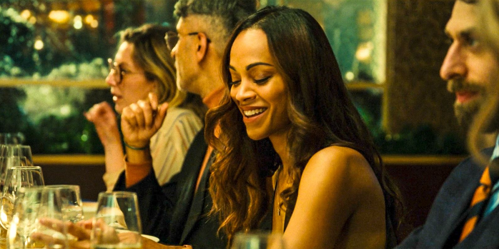 Rita Moro (Zoe Saldana) having fun during a dinner in Emilia Pérez