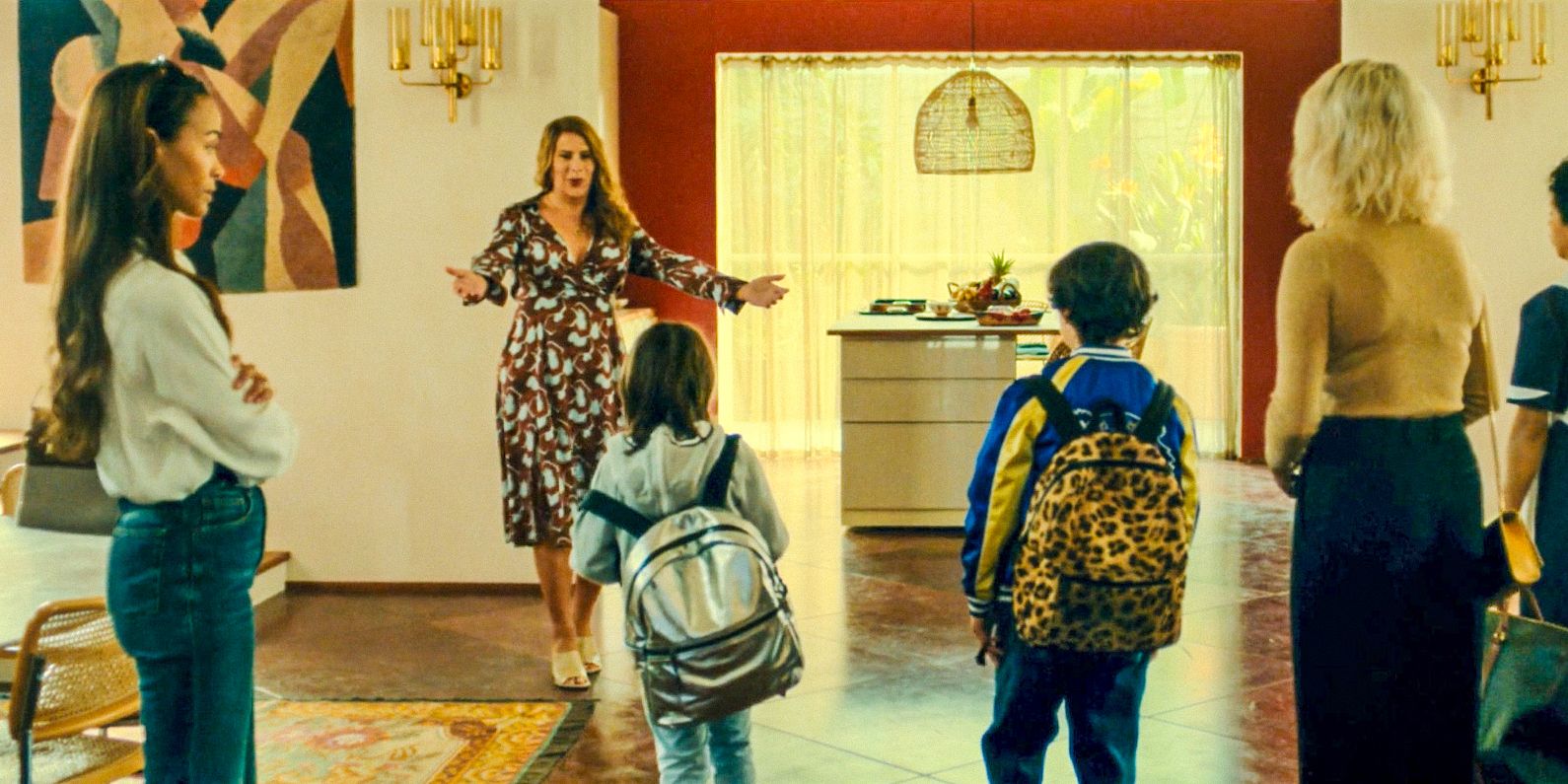 Emilia Pérez (Karla Sofía Gascón) happily welcomes her children and Jessi into her home in Emilia Pérez