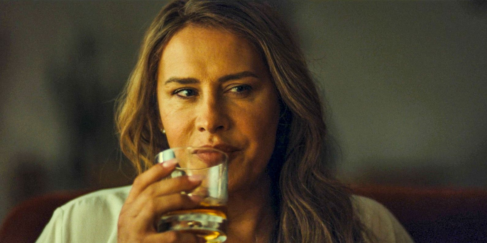 Emilia Pérez (Karla Sofía Gascón) is having a drink while talking with Jessi about El Manitas in Emilia Pérez