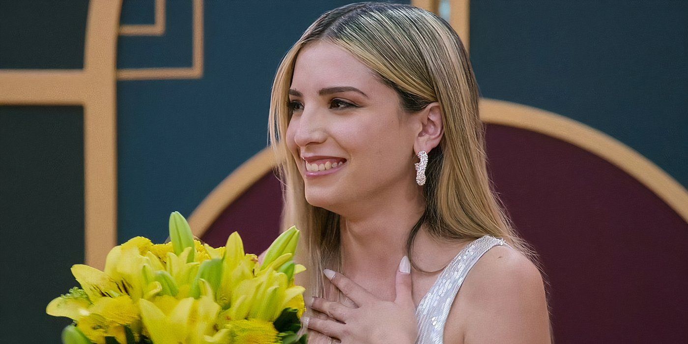 Love Is Blind: Argentina season 1 Emily Ceco smiling while holding flowers in one hand with the other hand on her chest