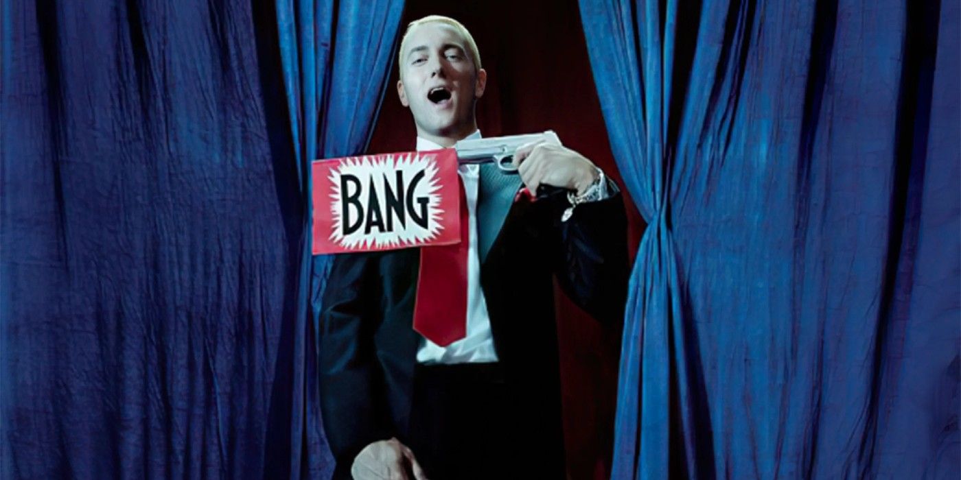 Eminem laughs with a fake prop gun in his hand for the Encore photoshoot