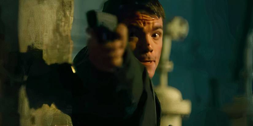 Gabriel Basso as Peter Sutherland pointing a gun in The Night Agent season 2