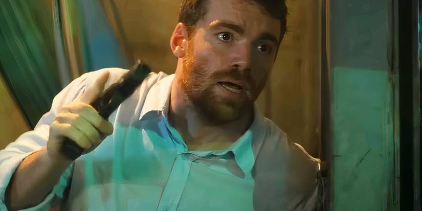 Gabriel Basso holding a gun in The Night Agent season 2