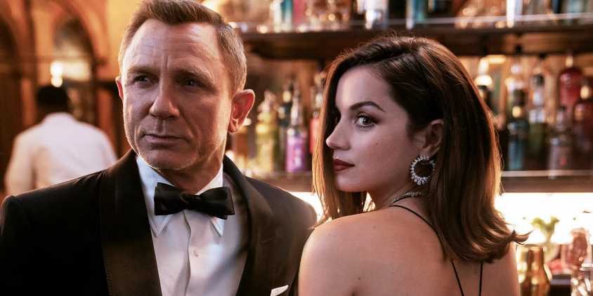 Close up of Daniel Craig as James Bond and Ana de Armas as Paloma in evening outfits in No Time To Die