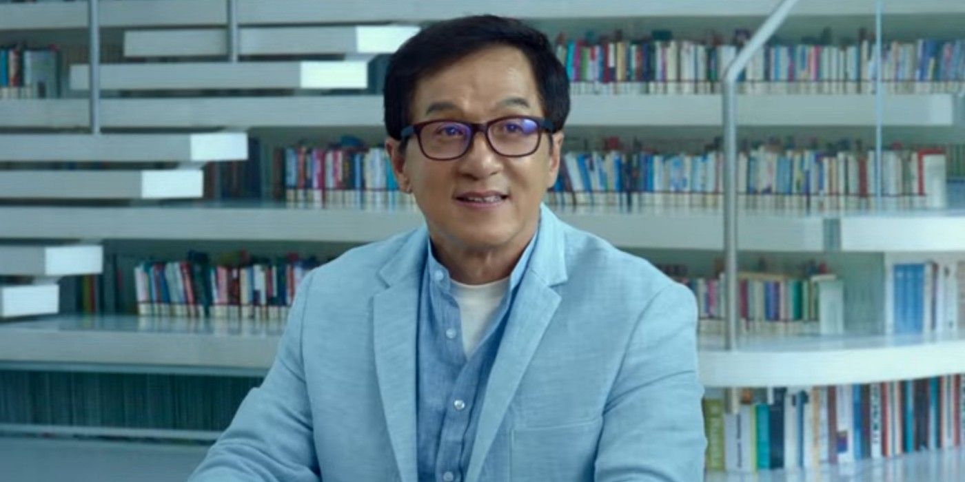 Jackie Chan sitting in a library smiling in A Legend