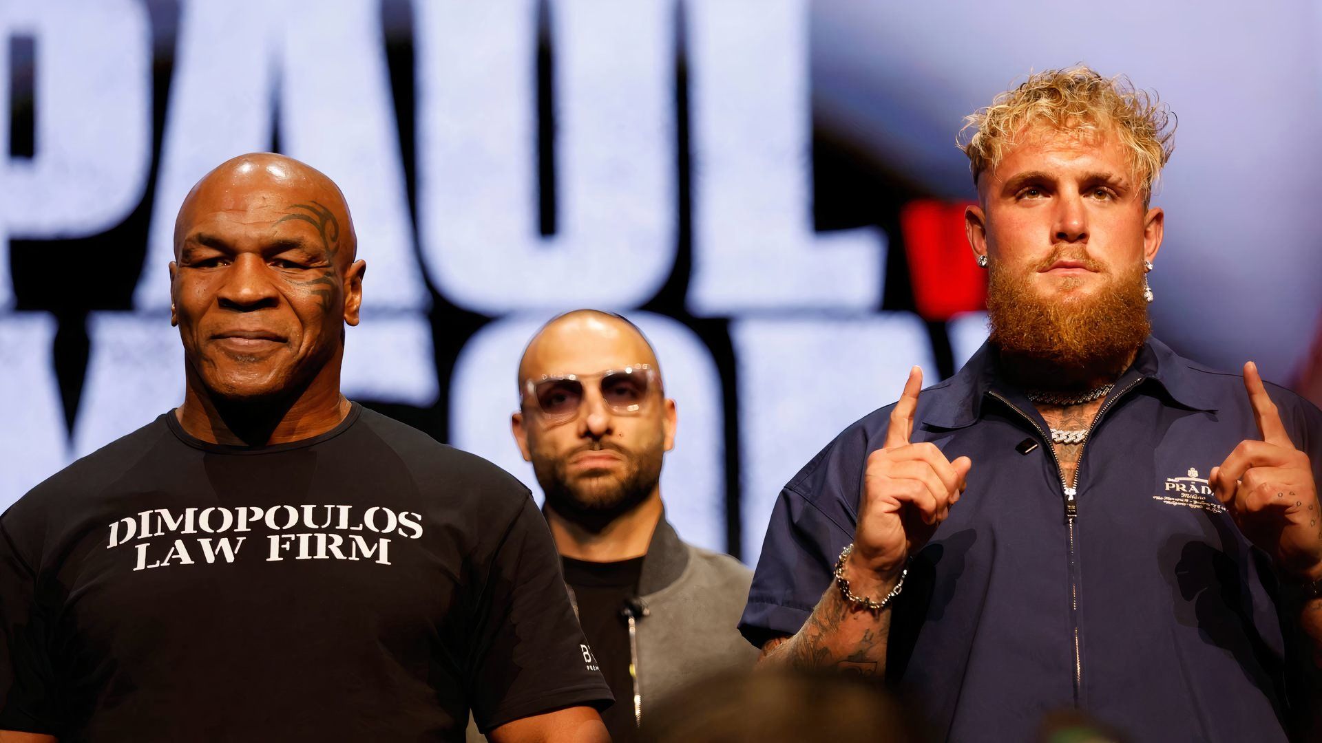 Jake Paul and Mike Tyson promote their fight on stage.