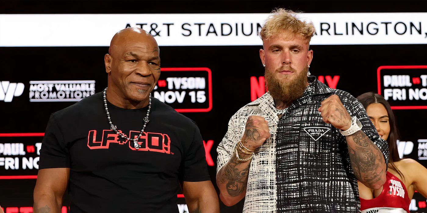 Jake Paul and Mike Tyson pose for the camera at a press conference.