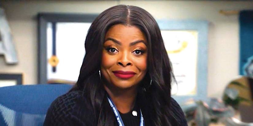 Janelle James' Ava sits at a desk smiling in Abbott Elementary season 4 episode 6