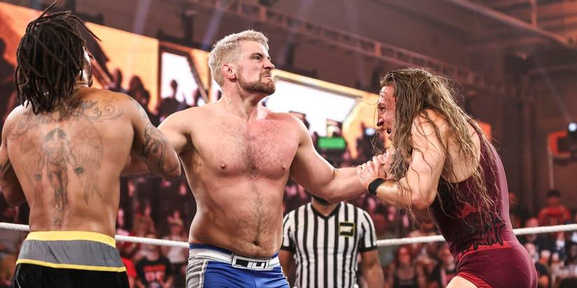 Joe Hendry grabs Pete Dunne and Wes Lee by the throat in WWE NXT