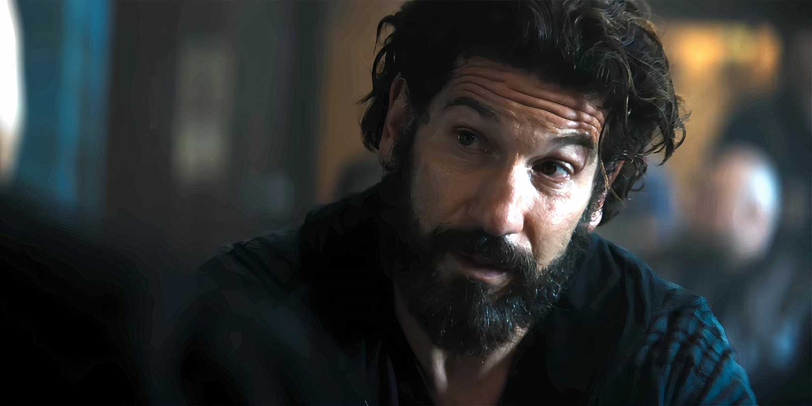 Jon Bernthal looking cautiously while talking to Charlie in The Amateur