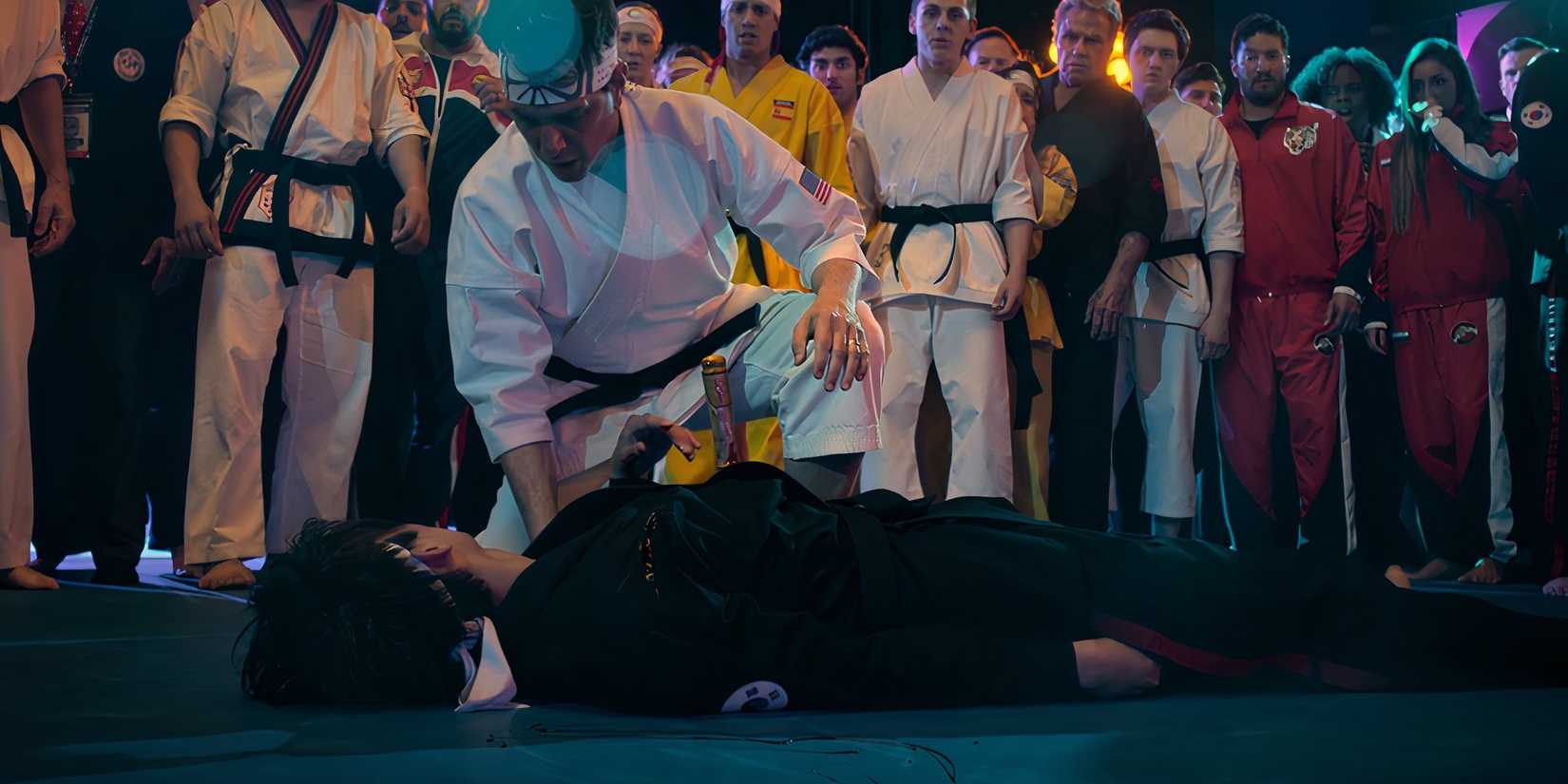 Daniel crouching over Kwon's body in Cobra Kai