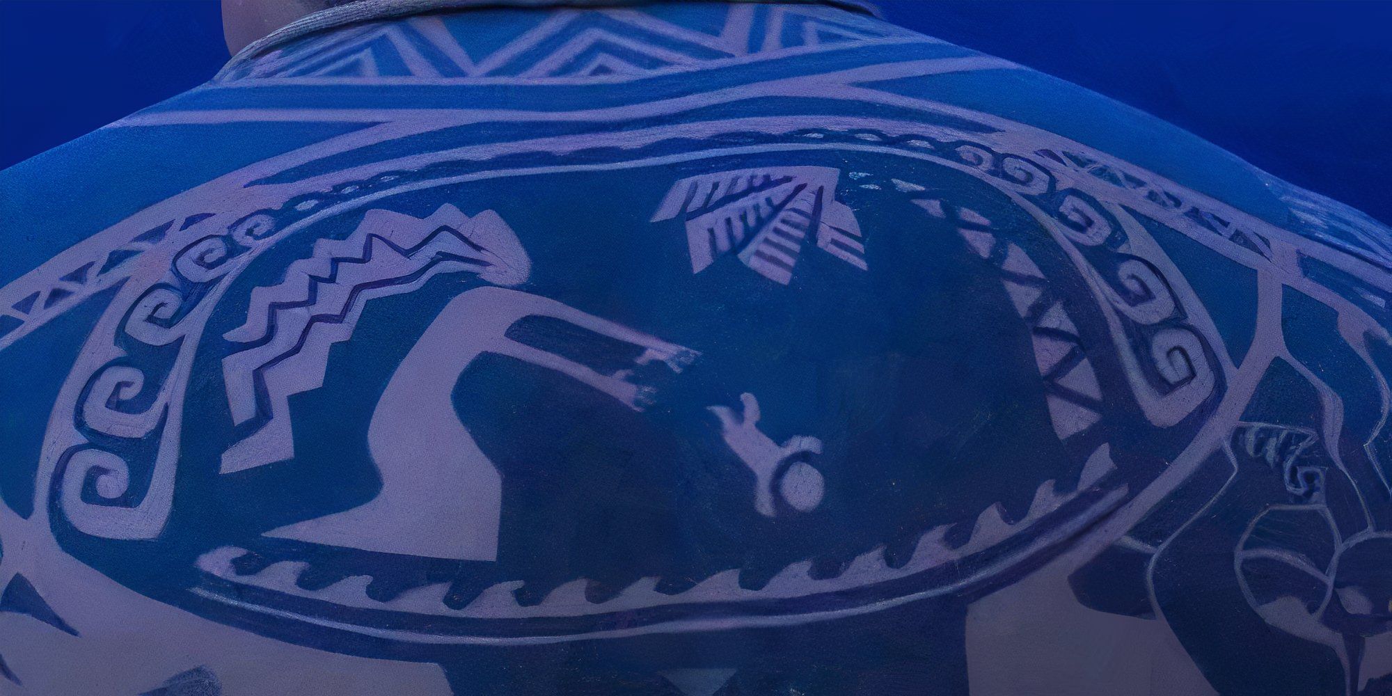 Maui's tattoo showing a baby being thrown into the ocean in Moana