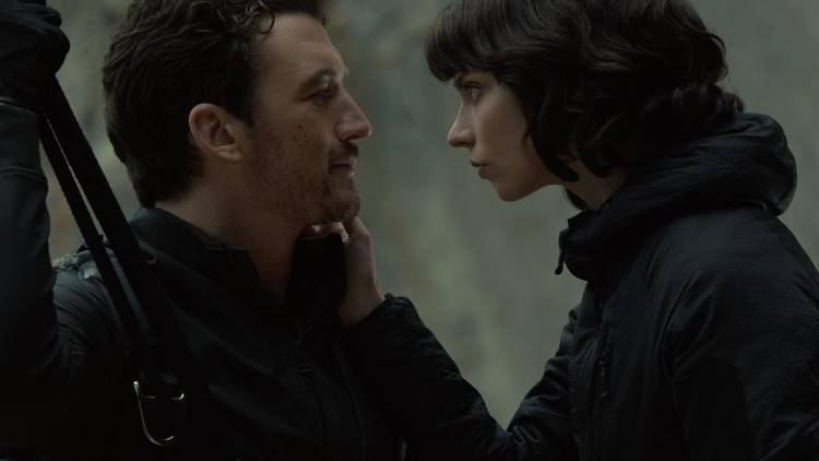 Miles Teller and Anya Taylor Joy staring into each other's eyes in The Gorge